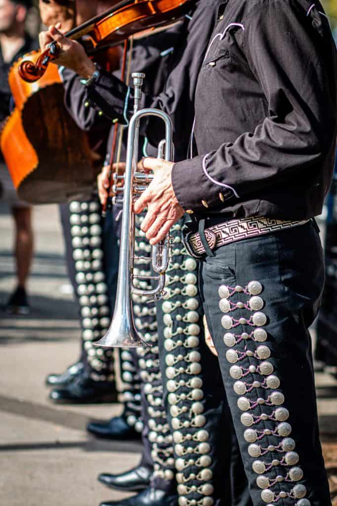 A band member holding a silver cornet.