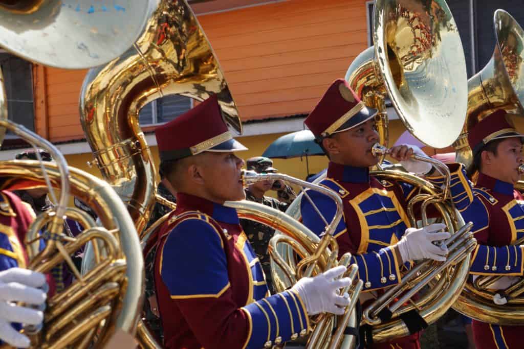 A group of sousaphone players in a marching band.