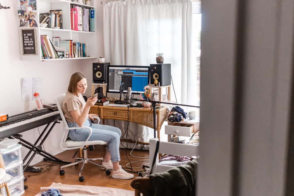 A woman sets up her recording equipment in a quiet room