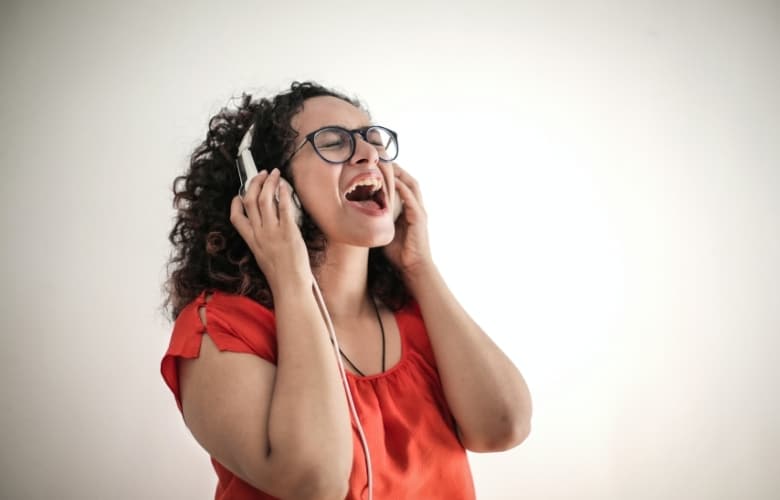 A woman singing with headphones on
