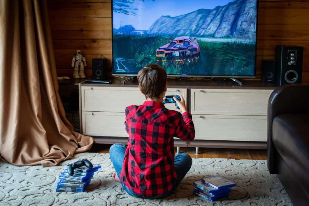 A child playing PS4 on a large monitor