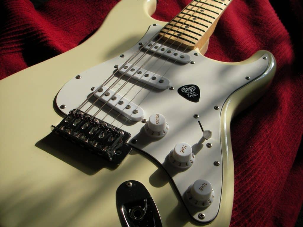 A close up of noiseless strat pickups on a guitar