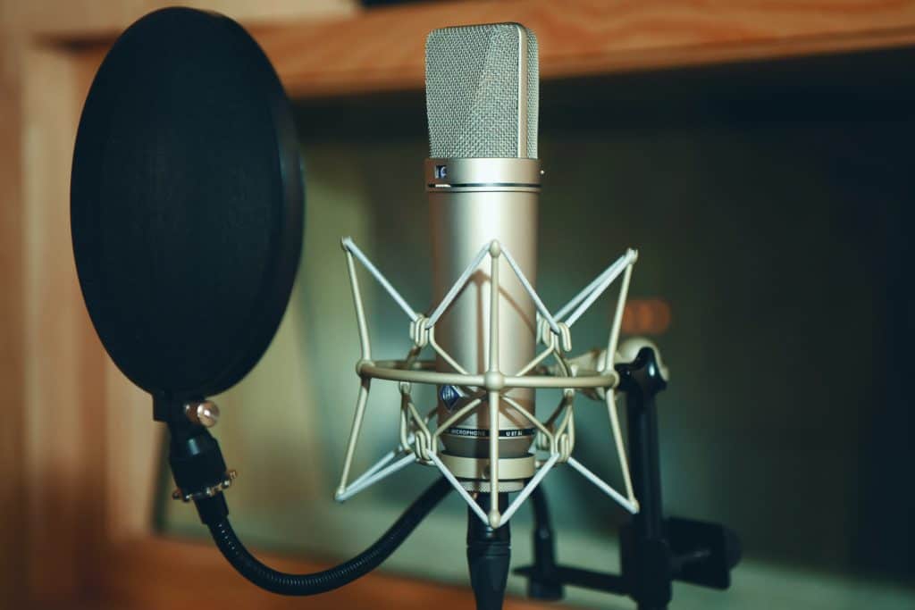 A microphone with a pop filter in a music studio