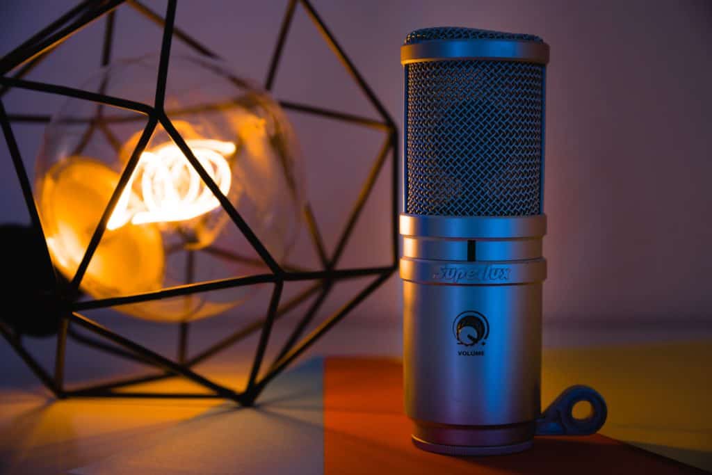 A condenser microphone with lamp on the background