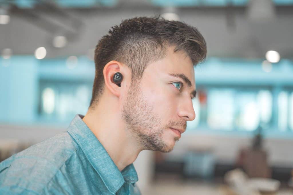 Young man wearing black earbuds