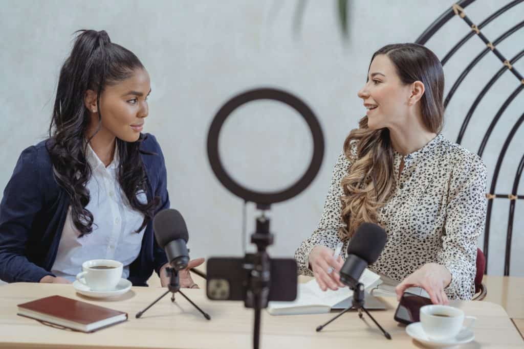 Two ladies having a conversation in a podcast