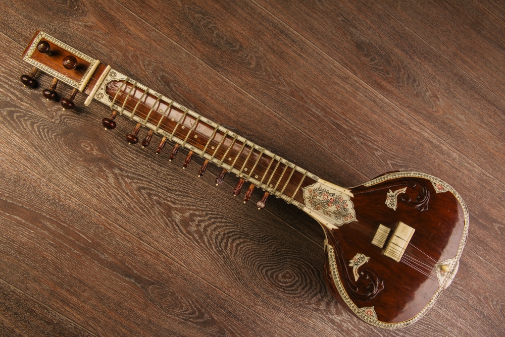 Indian Musical Instrument Sitar Lying On The Wooden Floor Image